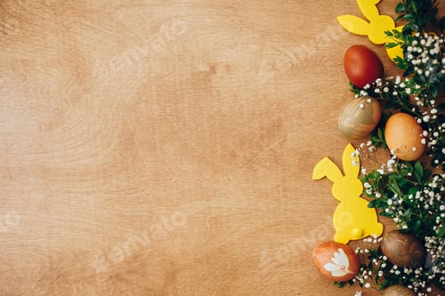 Preview: Stylish easter eggs and yellow bunny on rustic wooden table