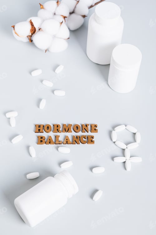 Preview: Food supplements for restoring hormonal balance on a blue background vertical view