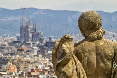 Preview: Statue looking at the view of Barcelona city from Montjuic hill on background of Sagrada Familia