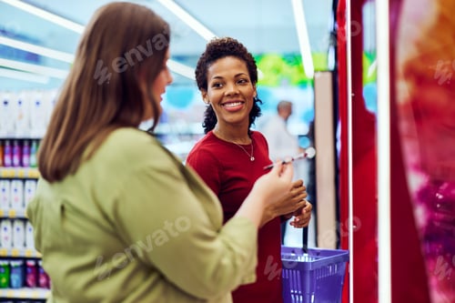 Preview: A plus-size woman buys makeup with her African friend in a beauty section.