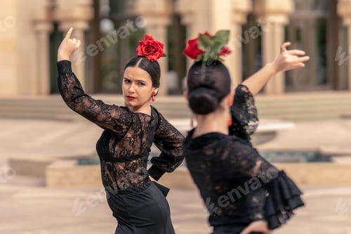 Preview: young flamenco dancer dressed in black dancing with her partner