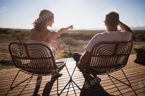 Preview: Senior couple sitting on chairs at the resort