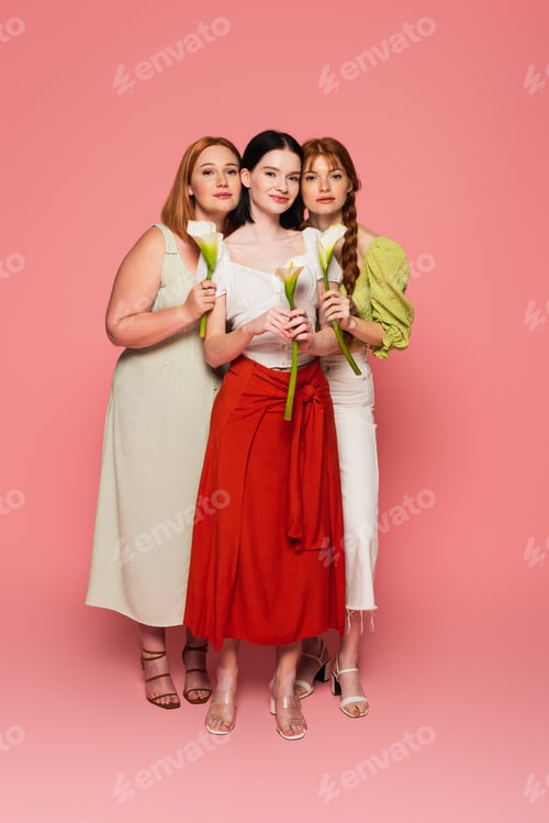 Preview: Body positive friends holding calla lilies on pink background