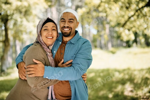 Preview: Portrait of happy Muslim couple embracing in nature and looking at camera.