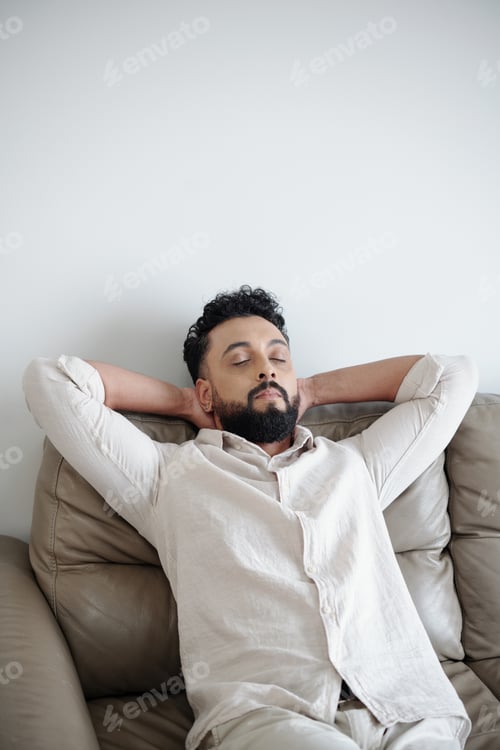 Preview: Man Leaning Back on Comfy Sofa