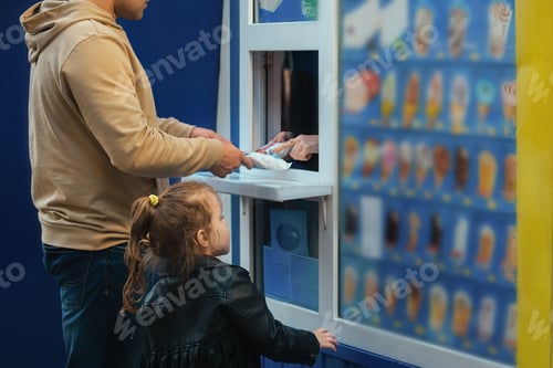 Preview: dad and daughter buy ice cream in a small shop