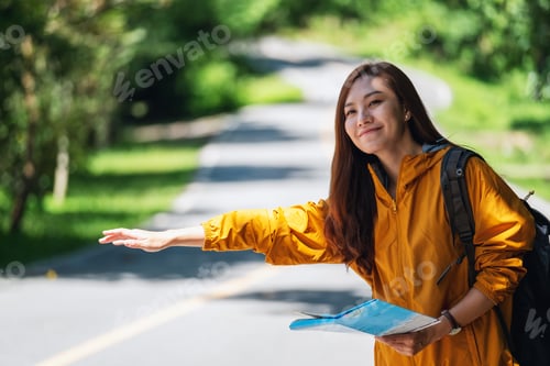 Preview: A young female traveler hitchhiking and stopping car on a mountains road