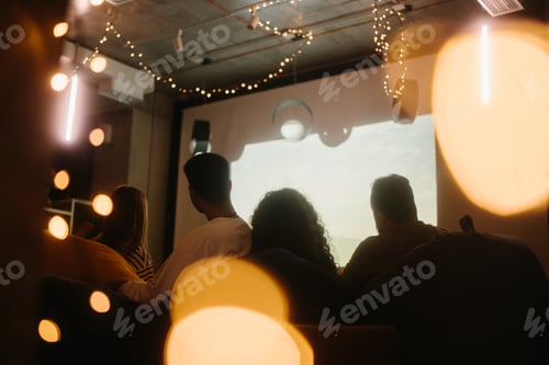 Preview: A group of friends are watching a movie in a home theater.