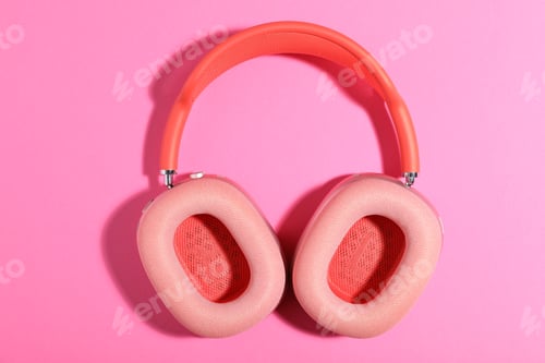 Preview: Pair of stylish headphones on pink background, top view