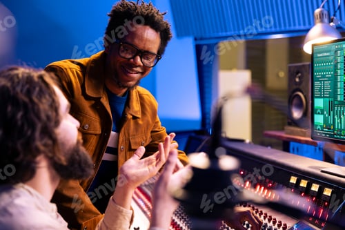 Preview: African american composer works with engineer in recording studio