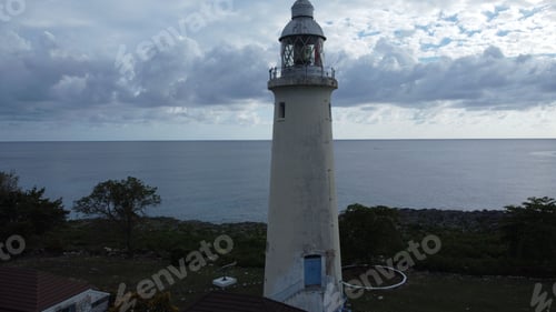 Preview: Old lighthouse against a bright sky with the backdrop of a sea
