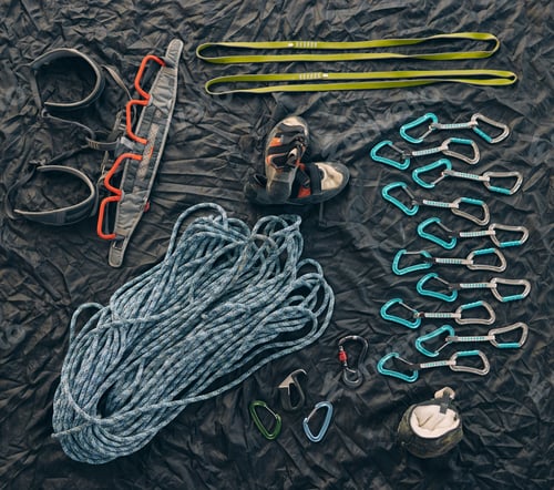 Preview: Closeup shot of a variety of carabiner hooks, rope, and other safety equipment used for rock or mou