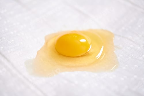 Preview: Raw egg yolk on white surface