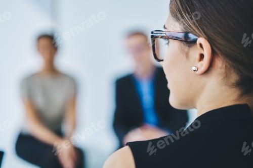 Preview: Caucasian female in glasses brainstorming in office interior
