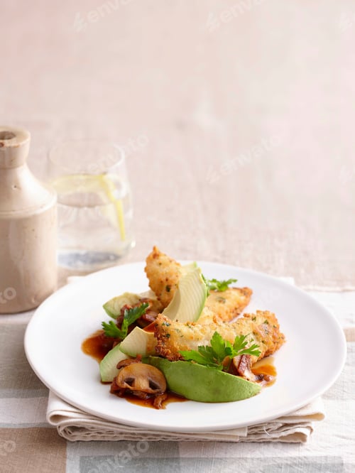Preview: Plate of chicken and avocado on table