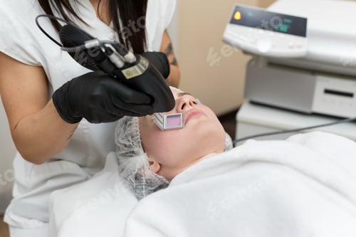 Preview: Hair removal cosmetology procedure from a therapist at cosmetic beauty spa clinic. Laser epilation