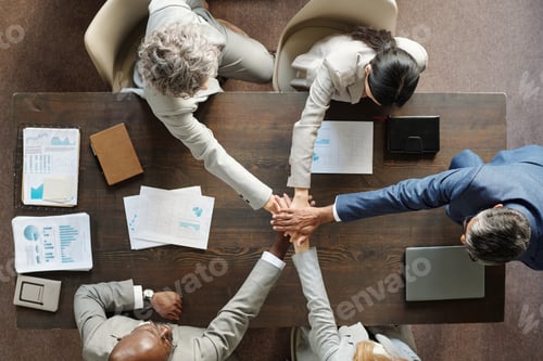 Preview: Diverse Group of Middle Aged Businesspeople Collaborating Around Table