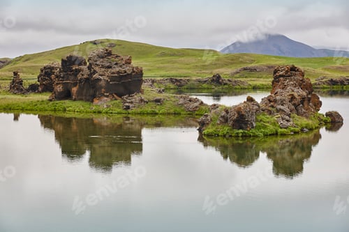 Preview: Basalt formations into the lake in Myvatn area. Icelandic landscape
