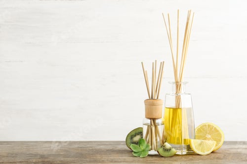 Preview: Composition with aromatic reed fresheners on wooden table against light background. Space for text