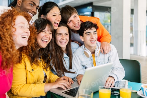 Preview: Young group of happy student friends standing together while studying on laptop
