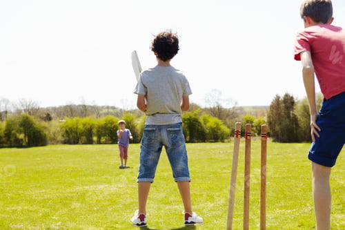 Preview: Boys playing cricket on field