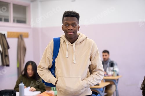 Preview: Confident male student standing in classroom at university institute