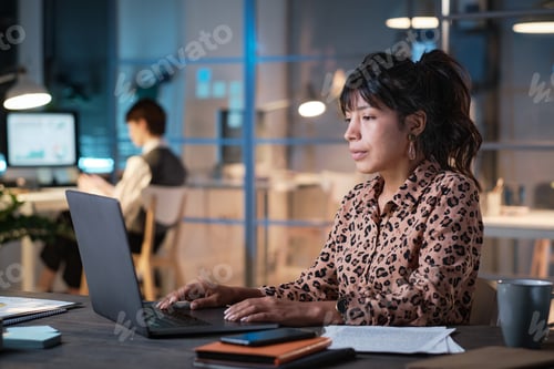 Preview: Businesswoman working on laptop at office