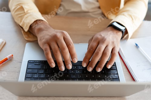 Preview: Man typing on laptop keyboard working remotely