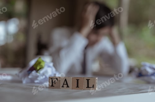 Preview: Employees feel stressed, failed and disappointed.FAIL Word text Written In Wooden Cube blocks