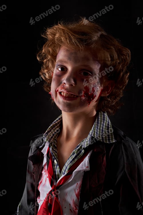 Preview: Vertical photo of a child disguised as a zombie with blood and glitter