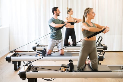 Preview: Three people exercising torson rotation at gym