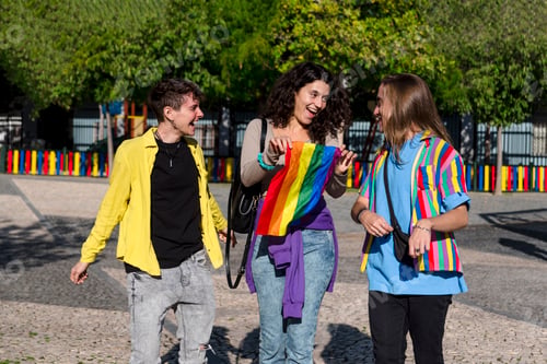 Preview: Young diverse friends walking on the street with the lgbt rainbow flag.