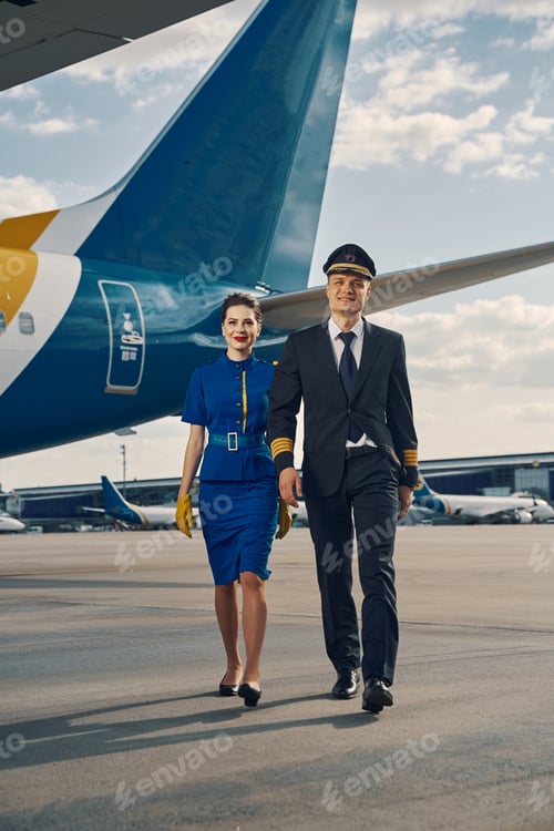 Preview: Aviator and a flight attendant going along the runway