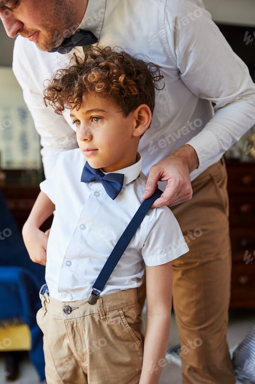 Preview: Father And Son Wearing Matching Outfits Getting Ready For Wedding At Home