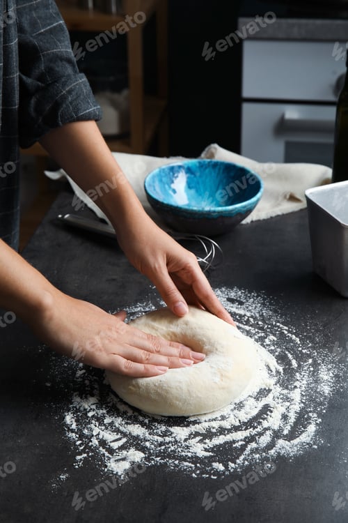 Preview: Woman kneading dough for pastry on table