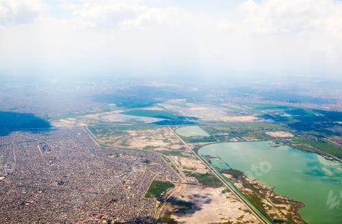 Preview: Mexico City seen from the heights with urban areas and airplane landing zone