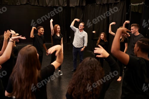Preview: Teacher With Male And Female Drama Students At Performing Arts School In Studio Improvisation Class