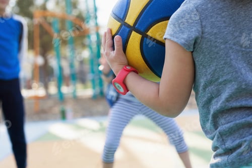 Preview: Children playing basketball in playground