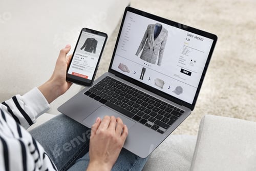 Preview: Woman with smartphone and laptop shopping online indoors, closeup
