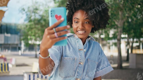 Preview: Girl teenager streaming online looking cellphone camera on street close up.