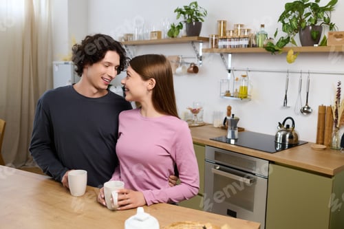 Preview: Happy couple sharing a moment in their cozy modern apartment kitchen