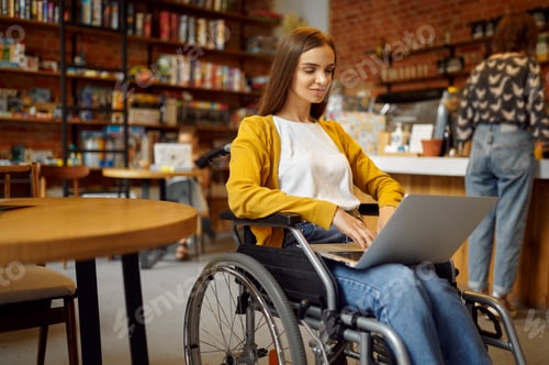 Preview: Disabled student in wheelchair works on laptop