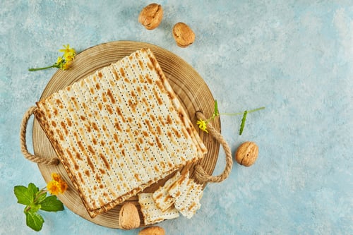 Preview: Pesach celebration concept - jewish Passover holiday. Matzah on wooden stand with nuts