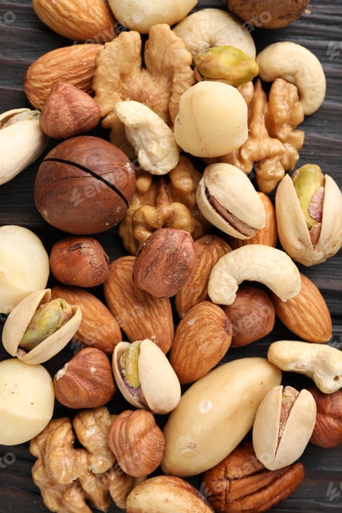 Preview: Mix of different nuts on wooden table, flat lay