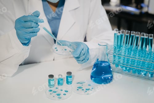 Preview: Female scientist researcher conducting an experiment working in the chemical laboratory.