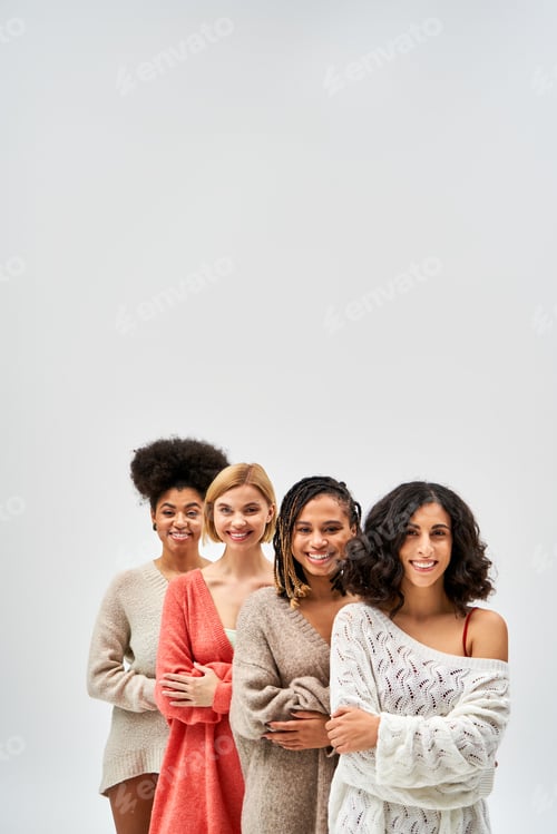 Preview: Positive multiethnic women in stylish knitted jumpers crossing arms