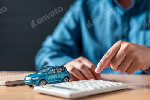 Preview: A man is pointing at a blue car on a calculator.