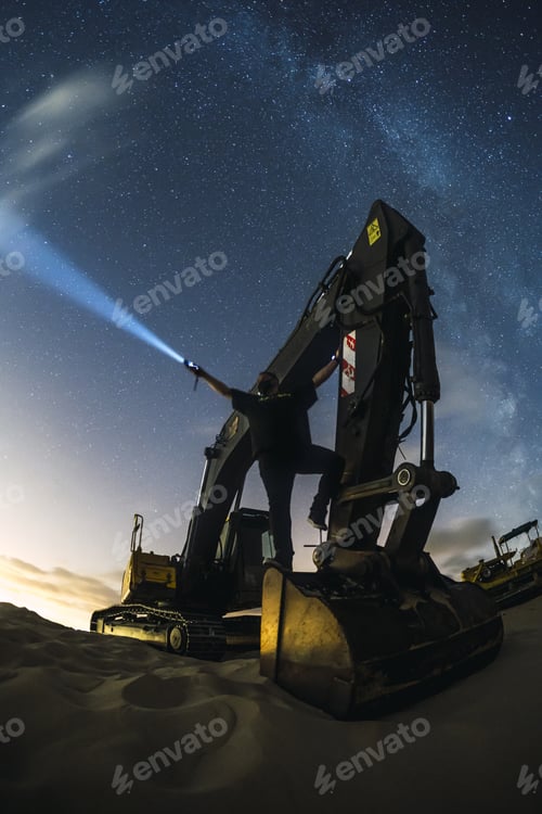 Preview: Excavator working under the night sky with the milky way in Valdevaqueros, Cadiz, Andalucia