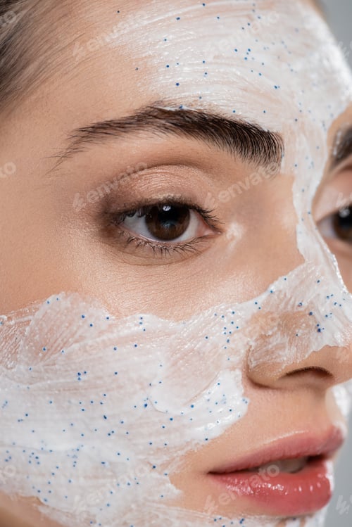 Preview: close up of young woman with face scrub