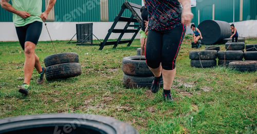 Preview: Participants in an obstacle course dragging wheels